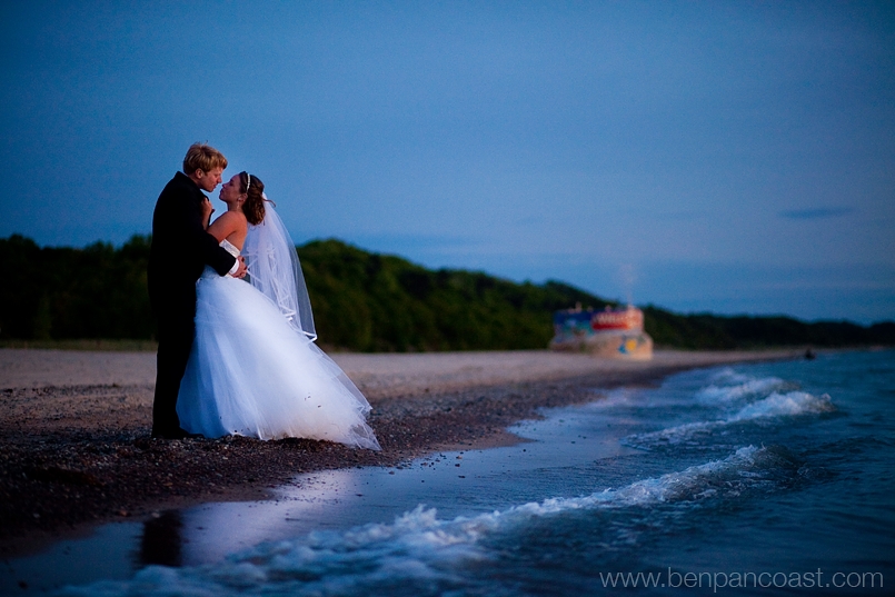 Wedding portraits on the beach at sunset by lake Michigan, in Southwest Michigan, by a wedding photographer.