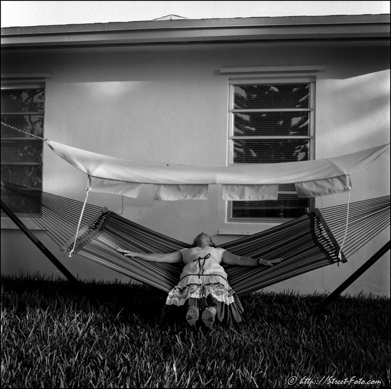 Woman sleeping in a hammock in the residential area of Kendall, Miami, USA, 2010. Street Photography of Miami, San Francisco and Key West by Emir Shabashvili, see http://street-foto.com, http://miamistreetphoto.com, http://miamistreetphotography.com or http://miamistreetphotographer.com