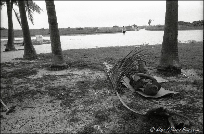 Homeless man sleeping at Lummus park in South Beach, Miami Beach, Florida, USA, 2010. Street Photography of Miami, San Francisco and Key West by Emir Shabashvili, see http://street-foto.com, http://miamistreetphoto.com, http://miamistreetphotography.com or http://miamistreetphotographer.com