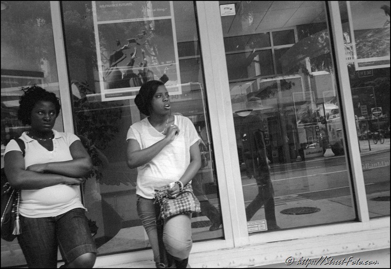 Two young women looking at man on Biscayne Boulevard in Downtown Miami, Florida, USA, 2011. Street Photography of Miami, San Francisco and Key West by Emir Shabashvili, see http://street-foto.com, http://miamistreetphoto.com, http://miamistreetphotography.com or http://miamistreetphotographer.com