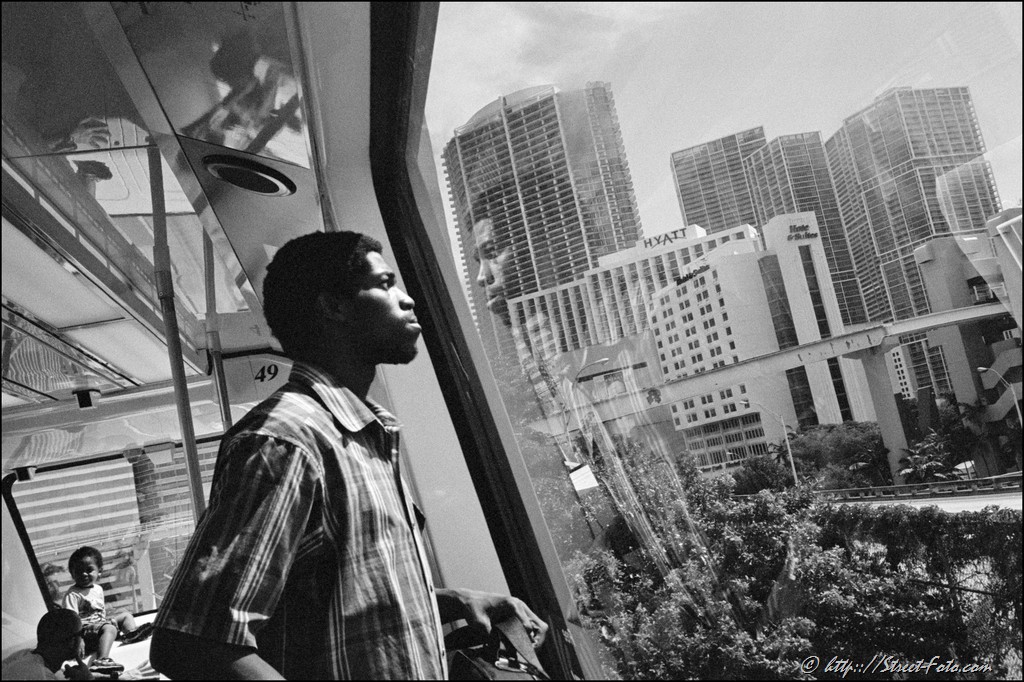 Man standing by the window in Metromover car, Downtown Miami, Florida, USA, 2011. Street Photography of Miami, San Francisco and Key West by Emir Shabashvili, see http://street-foto.com, http://miamistreetphoto.com, http://miamistreetphotography.com or http://miamistreetphotographer.com