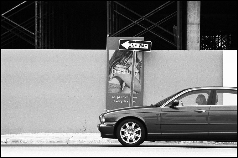 Woman riding BMW on NW 161st Street in Sunny Isles Beach, Miami, Florida, USA, 2007. Street Photography of Miami, San Francisco and Key West by Emir Shabashvili, see http://street-foto.com, http://miamistreetphoto.com, http://miamistreetphotography.com or http://miamistreetphotographer.com